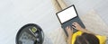 Top view of female freelancer sitting on floor near sofa at home and working on mockup laptop computer. Woman typing on Royalty Free Stock Photo