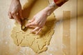 Top view of female hand cutting out biscuits from dough Royalty Free Stock Photo