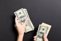 Top view of female hand giving some money, Close-up of counting one hundred dollar bills. Business concept on colorful background