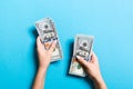 Top view of female hand giving some money, Close-up of counting one hundred dollar bills. Business concept on colorful background