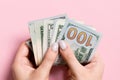 Top view of female hand holding a pack of money on colorful background. Various dollars. Business concept. Charity and tips