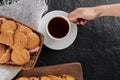 Top view. Female hand taking cup of tea. Background with homemade cookies Royalty Free Stock Photo