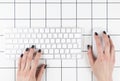 Top view female hand using computer keyboard. Hand typing on desktop office computer keyboard. Woman using laptop. Business lady Royalty Free Stock Photo