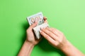 Top view of female hands counting money. One hundred and twenty dollar banknotes on colorful background. Salary concept. Bribe Royalty Free Stock Photo