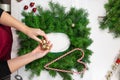 Top view female hands decorating a wreath with Christmas balls . DIY Christmas wreaths Royalty Free Stock Photo