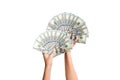 Top view of female hands giving a fan of dollar bills on isolated background. Profit and luxury concept Royalty Free Stock Photo