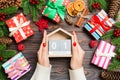 Top view of female hands holding a calendar on wooden background. The first of January. Holiday decorations. New Year concept Royalty Free Stock Photo