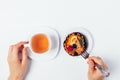 Top view female hands holding cup of tea and fork Royalty Free Stock Photo