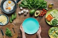 top view of female hands holding empty plate with various ingredients for healthy Royalty Free Stock Photo