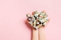 Top view of female hands holding a lot of rolled up dollar banknotes on colorful background. Poverty concept. Credit concept Royalty Free Stock Photo