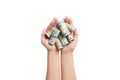 Top view of female hands holding a lot of rolled up dollar banknotes on white isolated background. Poverty concept. Credit concept Royalty Free Stock Photo