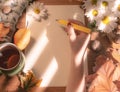 Top view of female hands holding a pencil and autumn dry leaves Mockup clipboard with a blank sheet of white paper. Creative Royalty Free Stock Photo