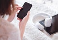 Top view of female hands holding smartphone. Woman surfing internet, social networks or chatting with friends. Copy space on Royalty Free Stock Photo