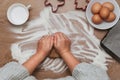 Top view of female hands kneading dough for Christmas cookies on table Royalty Free Stock Photo