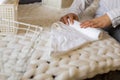 Top view female hands neatly folded white clean towels in case box use Marie Kondo organizing method Royalty Free Stock Photo