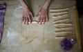 Top view, female hands preparing dough on kitchen table Royalty Free Stock Photo