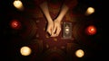 Top view, female hands on the table, deck of tarot cards laying next to her. Royalty Free Stock Photo