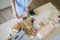 Top view female hands use labeler electronic device for marking different pasta closeup POV shot