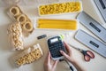 Top view female hands use labeler electronic device for marking different pasta closeup POV shot