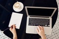 Top view of female hands working on laptop with blank black screen Royalty Free Stock Photo