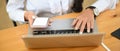 Top view female holding mobile phone and typing her laptop computer. Royalty Free Stock Photo