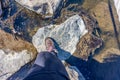 Top view of a female leg in black pants and hiking boots walking across the stepping stones Royalty Free Stock Photo