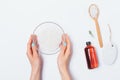 Top view female's hands holding bowl of sea salt