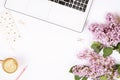 Top view of female worker desktop with laptop, flowers and different office supplies items. Feminine creative design workspace. Royalty Free Stock Photo