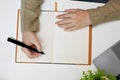 Top view, Female writing her diary, taking notes on her notebook, doing homework Royalty Free Stock Photo