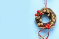 top view of festive Christmas wreath on light blue background. Christmas wreath Royalty Free Stock Photo