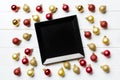 Top view of festive plate with red and golden baubles on wooden background. Christmas decorations and toys. New Year advent Royalty Free Stock Photo