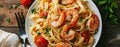 Top view of fettuccine pasta with shrimp, tomatoes, and herbs Royalty Free Stock Photo