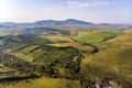 Top view of the field in Altai.Autumn view. Hilly terrain. Yellow slopes and trees contrast with green fields Royalty Free Stock Photo