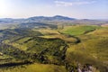 Top view of the field in Altai.Autumn view. Hilly terrain. Yellow slopes and trees contrast with green fields