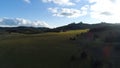 Top view of a field of grass on the hills on a Sunny day. Shot. Beautiful view of the picturesque nature in the distance