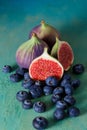 Top view of figs and blueberries on a green old table. Copy space.