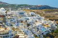 top view of Fira city architecture, mountains and buildings in background of Santorini, Greece