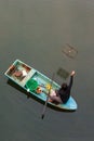 Top view, fishermen with traditional crab trap sitting on boat in the river of mangrove forest. beautiful reflection. Trat,