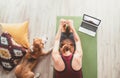 Top view at fit sporty healthy woman sit on mat in Paschimottanasana pose, doing breathing exercises, watching online yoga class