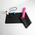 Top view of fitness mats, dumbbell, skipping rope, and a thermos water bottle
