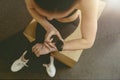 Top view of fitness woman looking at smartwatch on her wrist while resting after work out Royalty Free Stock Photo