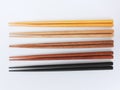 Top view of five pairs wooden chopsticks are arranged isolated on white background.