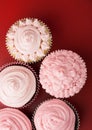 Top view on five pink cupcake on red background Royalty Free Stock Photo