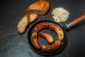 Top view five ruddy meat wieners fried in large frying pan