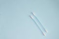 Top view, flat bed, two plastic cotton swabs neatly arranged on a pale blue background, the concept of cleanliness and hygiene Royalty Free Stock Photo