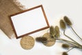 Top view flat lay autumn composition. Blank brown frame, dried barbed plants, straw work and sackcloth Royalty Free Stock Photo