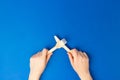 Top view and flat lay of bamboo wooden cutlery isolated on blue background. Female hands holding fork and knife. Zero waste Royalty Free Stock Photo