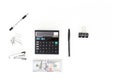 Top view flat lay of a black calculator, stack of one hundred dollar bills, and office stationery on a clean white background Royalty Free Stock Photo