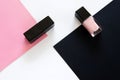 Top view flat lay of classic pair of black shoes and black and pink nail polishes Royalty Free Stock Photo
