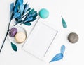 Top view flat lay Blank photo frame mockup with macarons and blue leaves Royalty Free Stock Photo